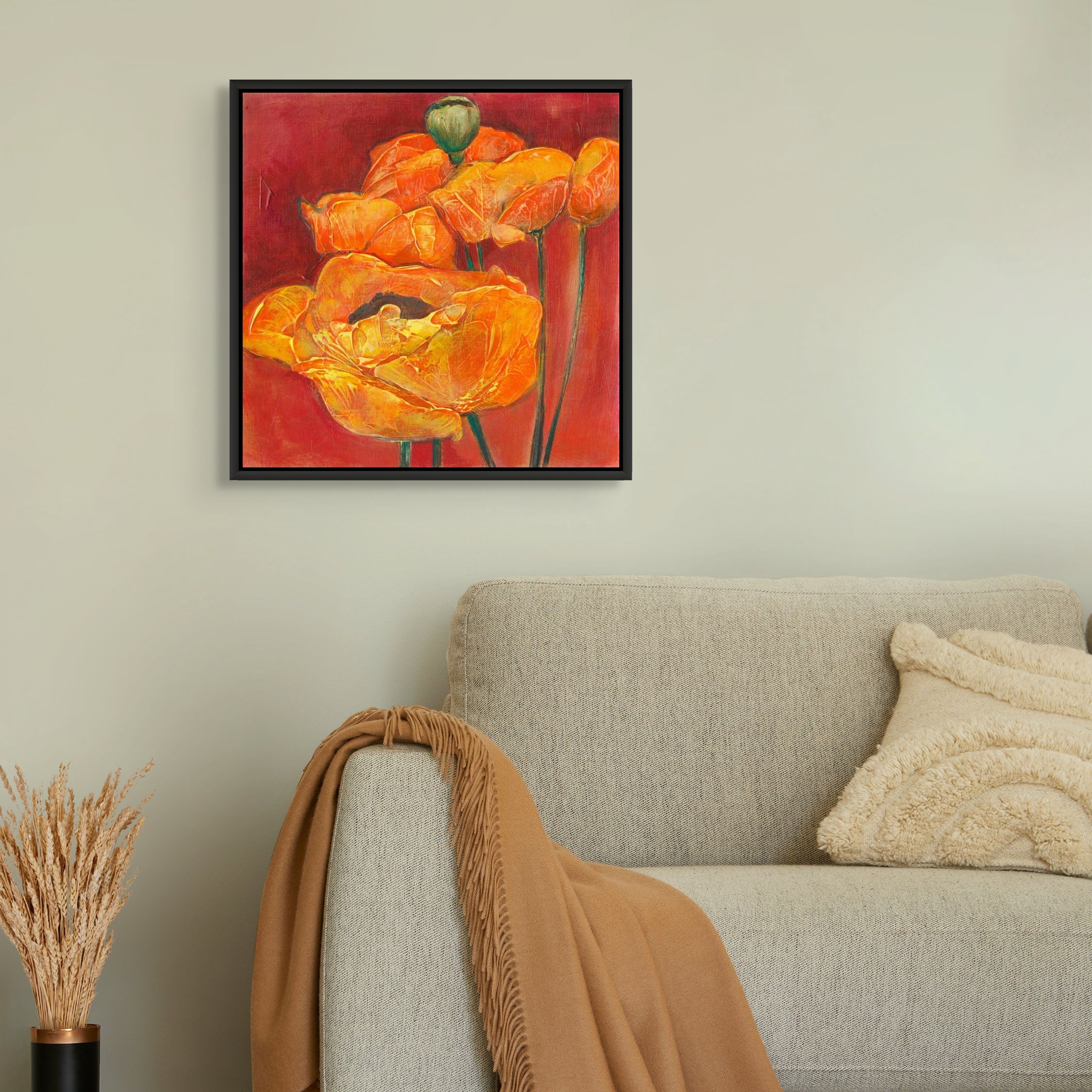 Framed canvas print of an original acrylic painting of orange poppies on a red background by Denise Souza Finney.  Framed in a black floater frame.