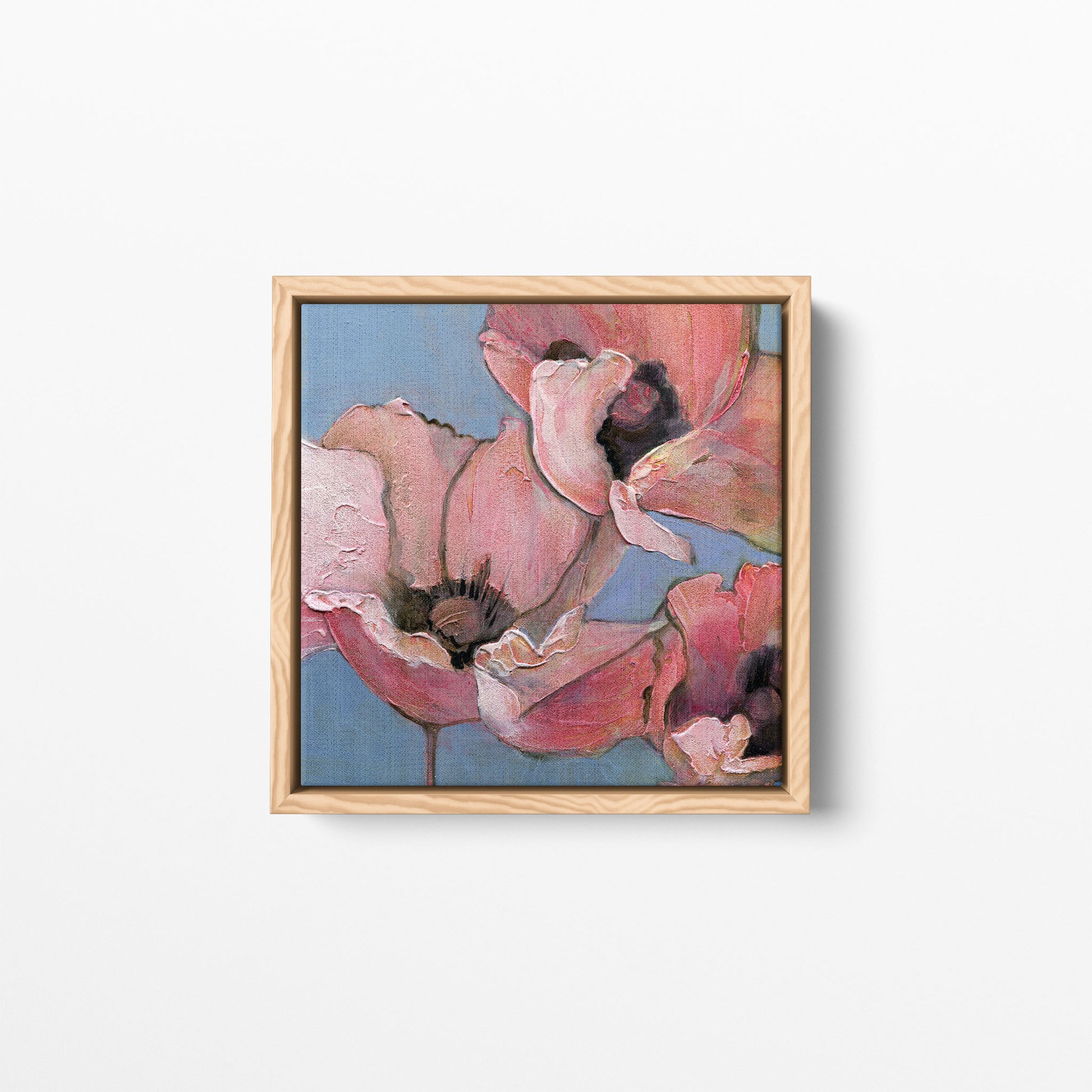 A 12x12 inch acrylic painting of poppies in shades of pink, peach, and blue. Framed in a natural wood frame.