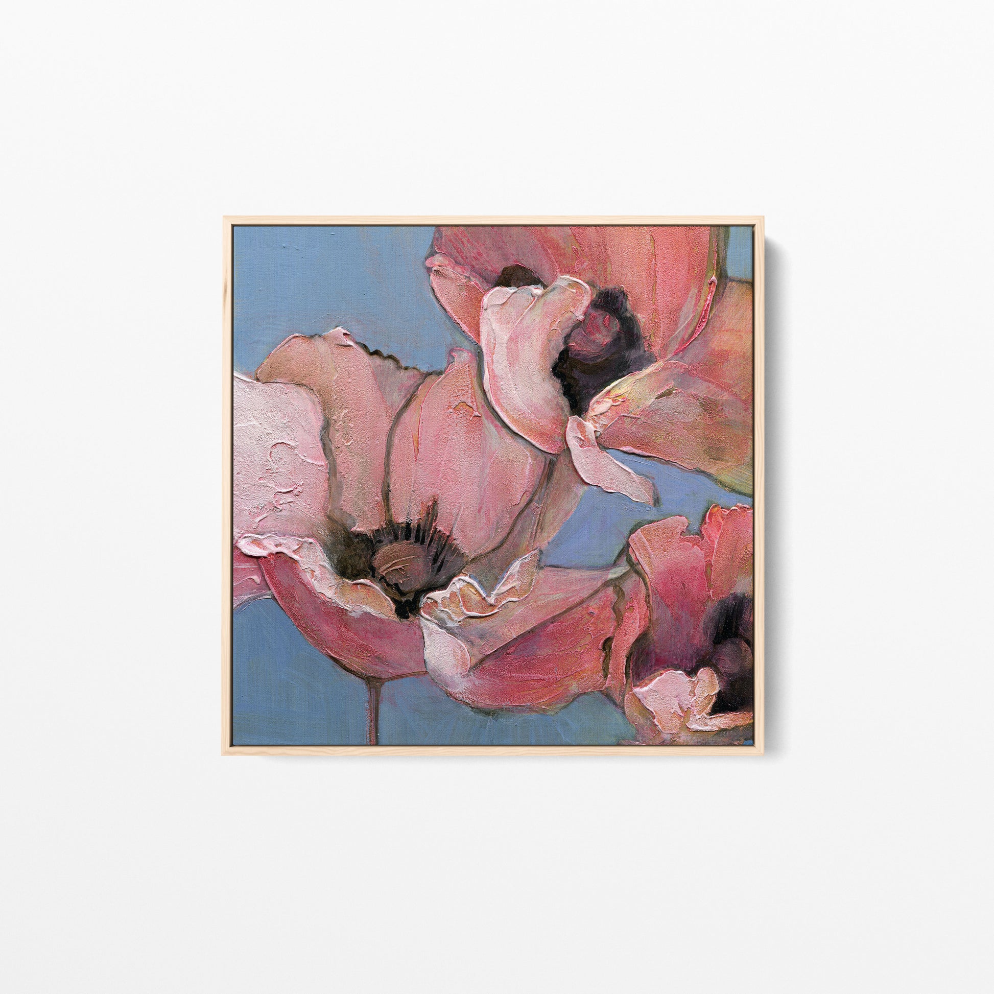 An acrylic painting of poppies in shades of pink, peach, and blue. Framed in a natural color wood frame.