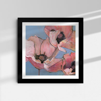 Framed artwork of a pink flower against a blue background