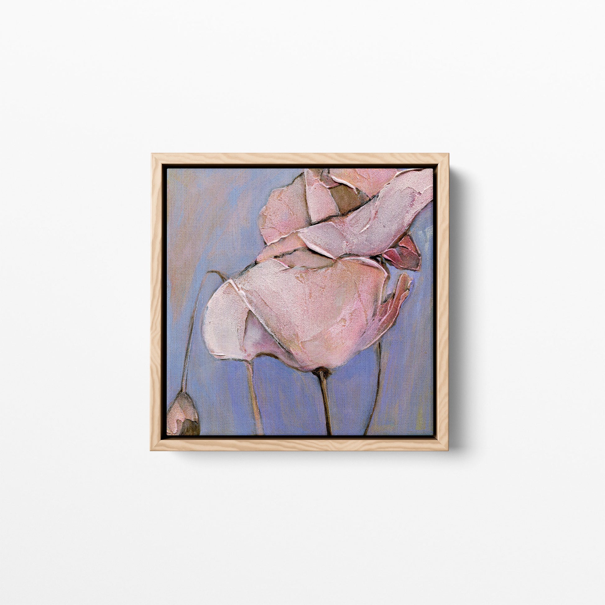 A 12x12 inch print of an acrylic painting of a close-up view of a poppy flower with soft blues and pink/peach hues. Framed in a natural wood frame.