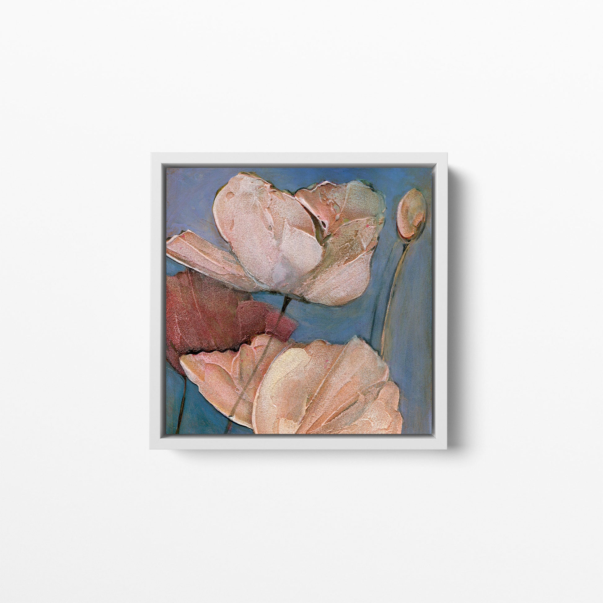 Canvas print of an acrylic painting of pink and white poppies on a blue background. Framed in a white wood frame.