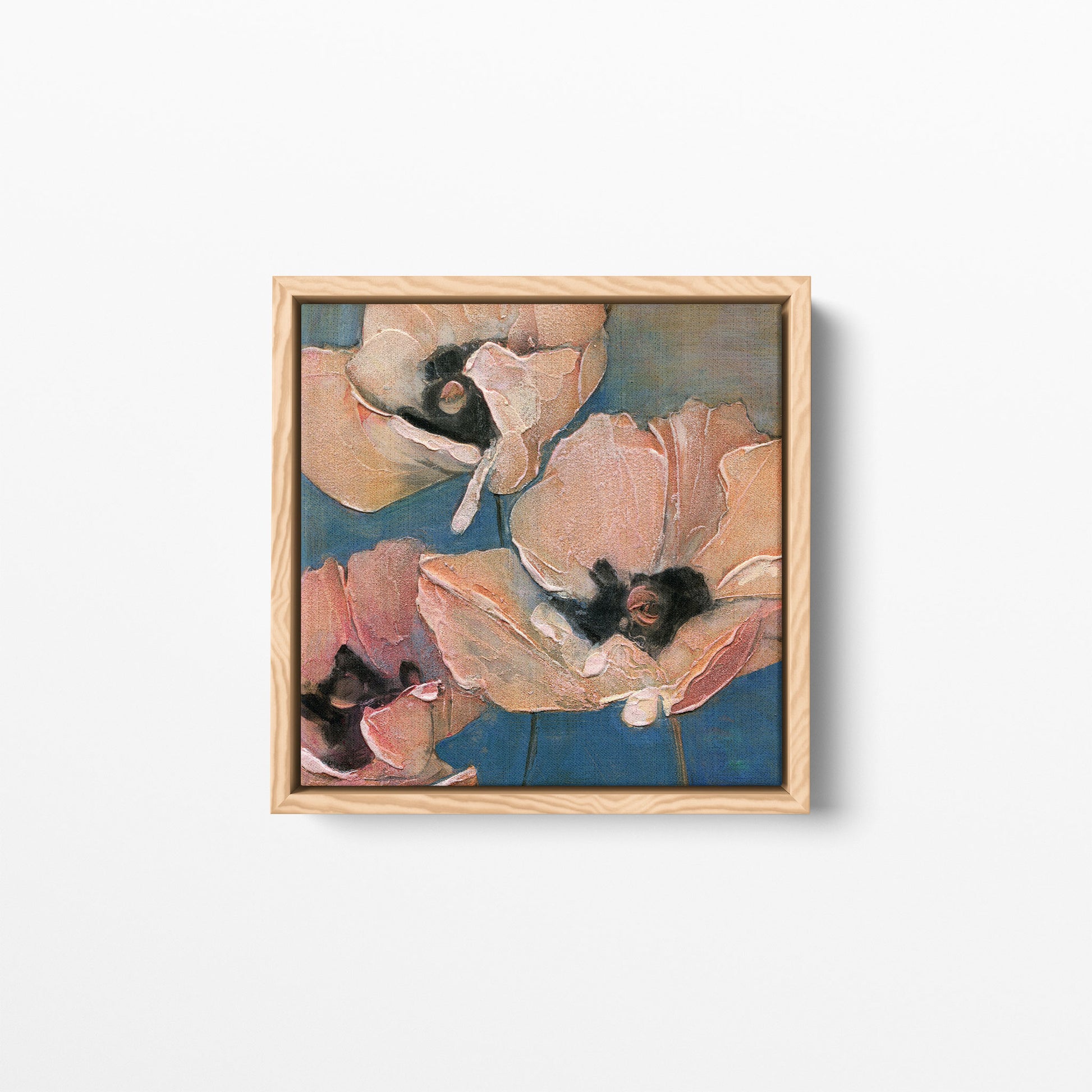 A close-up floral composition art print featuring three pink poppies with textured petals and dark centers against a muted blue background. Framed in a natural wood frame.