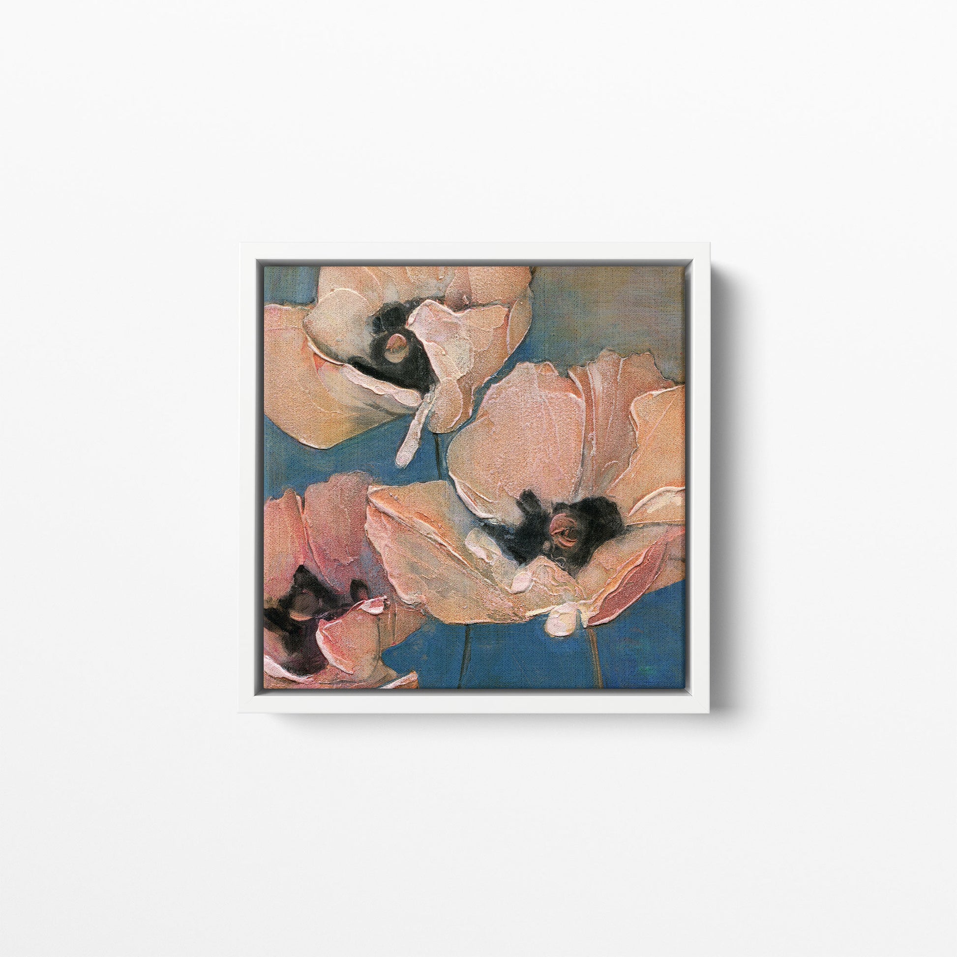 A close-up floral composition art print featuring three pink poppies with textured petals and dark centers against a muted blue background. Framed in a white wood frame.